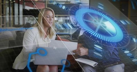 Business Professionals Collaborating with Holographic HUD on Laptop in Modern Office Lounge