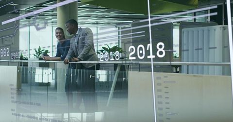 Business Professionals Discussing Financial Graphics in Modern Office