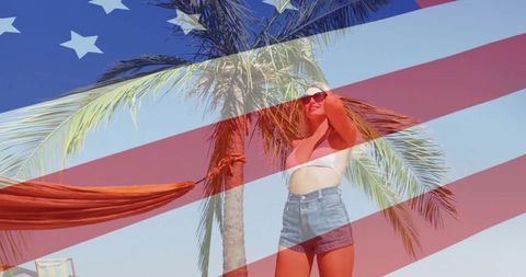 Woman relaxing on tropical beach celebrating american pride with flag overlay