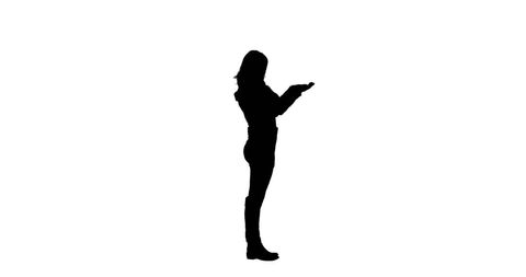 Silhouette of woman holding imaginary object with copy space