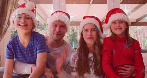 Happy Family Celebrating Christmas in Santa Hats at Home