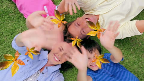 Caucasian Family Having Fun with Falling Autumn Leaves