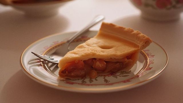 Slice of Fruit Pie on Elegant Patterned Plate with Fork