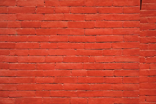 This vibrant red brick wall serves as a strong background element in various design projects. Ideal for use as a backdrop in both digital and print mediums, it creates a vivid and eye-catching display. It can be used in architectural presentations, interior design projects, advertisements, or website backgrounds.