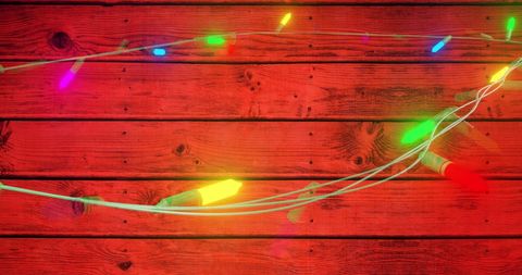 Festive Multicolor String Lights on Rustic Wooden Background
