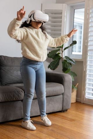 African american girl exploring virtual reality in living room wearing white vr headset