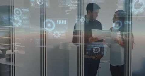 Business Team Studying Data Displays in Modern Office Setting