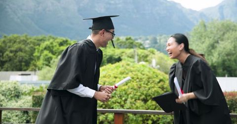 Joyful Outdoor Graduation Celebration with Diplomas and Caps