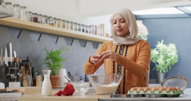 Muslim Woman Baking in Modern Kitchen, Cracking Egg into Bowl - Download Free Stock Images Pikwizard.com