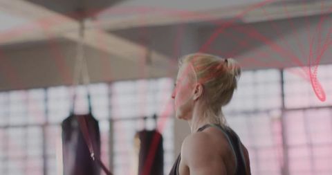 Fit Woman Training with Battle Ropes in Modern Gym