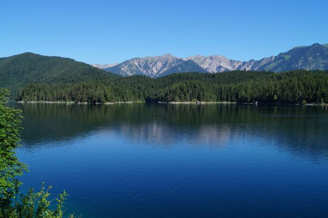Serene Mountain Landscape with Clear Lake, Green Forest, Blue Sky - Download Free Stock Photos Pikwizard.com