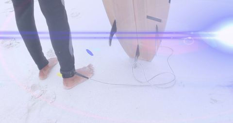 Light beams enhance surfer experience on sandy beach