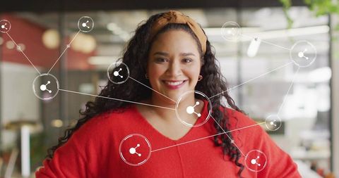 Confident professional woman in modern networked workspace