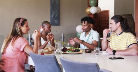 Friends Chatting and Sharing Snacks at a Relaxed Gathering