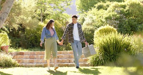 Happy Couple Walking Hand in Hand Enjoying Nature - Download Free Stock Images Pikwizard.com