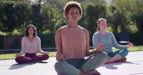 Women Practicing Mindfulness Meditation Outdoors in Sunlight