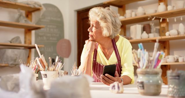 Elderly Potter Reflecting in a Pottery Studio - Download Free Stock Images Pikwizard.com