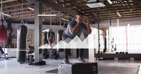 Athlete jumping on 20-inch plyo box with performance data overlay in modern boxing gym