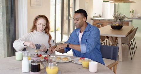 Couple Enjoying Breakfast at Home Dining Table