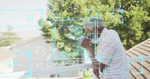 Elderly man enjoying coffee with digital graphical overlay outdoors