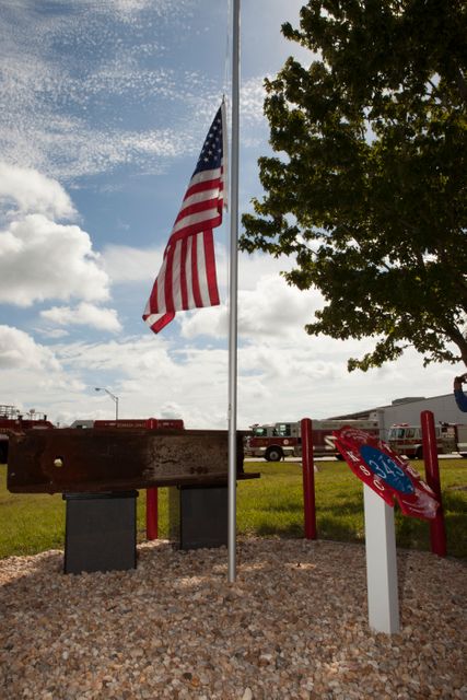 A memorial to the 343 first responder victims of the Sept. 11, 2001, terror attacks stands at Fire Station 1 at NASA's Kennedy Space Center during its dedication on Sept. 11, 2015. A section of steel I-beam from the World Trade Center in New York forms the centerpiece of the monument.