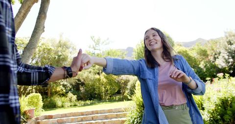 Happy Couple Walking in Sunny Garden Embracing Togetherness