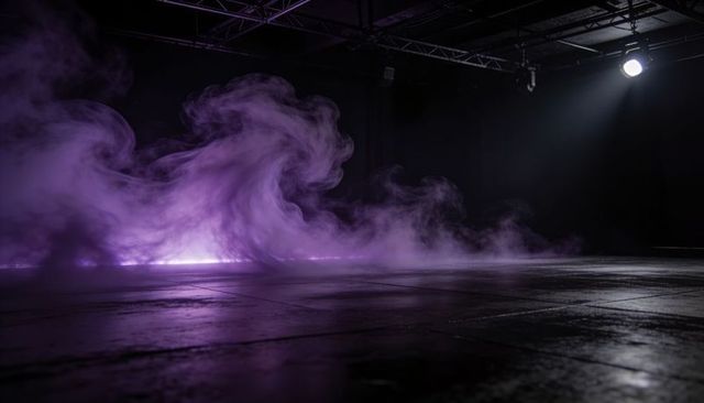 Purple fog drifting across black box stage spotlight and truss reflections on shiny tiles