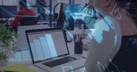 Businesswoman analyzing spreadsheet on laptop in open office with digital data overlay