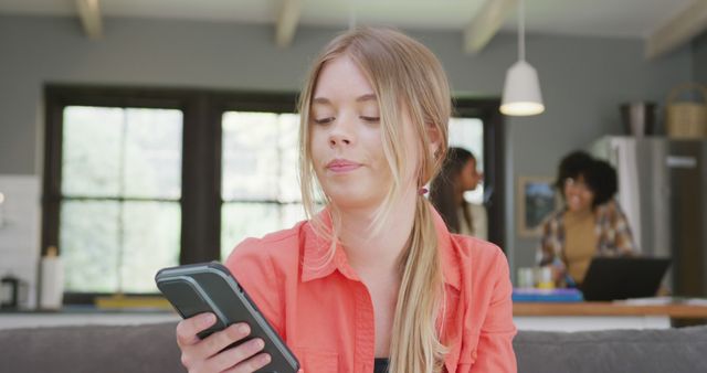 Teenage Girl Holding Smart Phone in Modern Living Room Interior - Download Free Stock Images Pikwizard.com