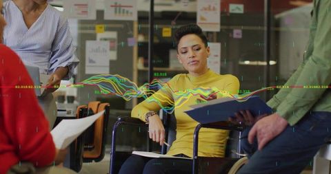 Focused businesswoman leading data analysis discussion in modern office