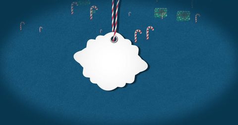 Gift tag on blue background with candy canes and presents