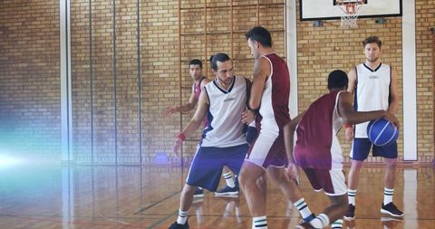 Energetic basketball team practice on indoor court