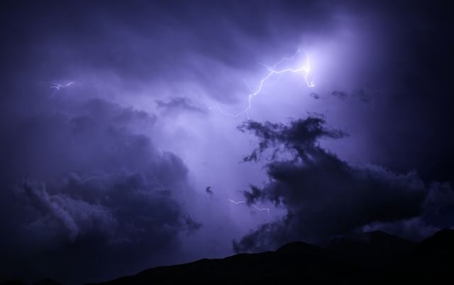 Dark clouds and powerful lightning dominate the dramatic night sky. Suitable for use in dynamic weather-related content, electric power demonstrations, atmospheric nighttime scenes, storytelling backdrops, or natural phenomena exhibitions. Perfect for dramatizing headlines in blogs or articles about thunderstorms or electricity.