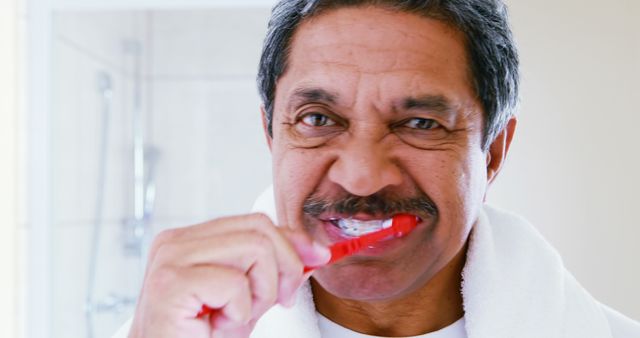 Senior Man Brushing Teeth in Bathroom - Download Free Stock Images Pikwizard.com