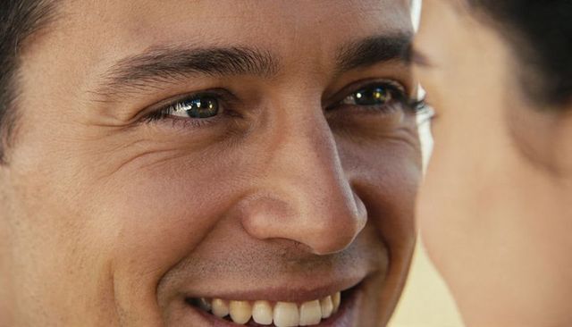 Smiling man gazing at partner in intimate close-up showing warmth and genuine connection
