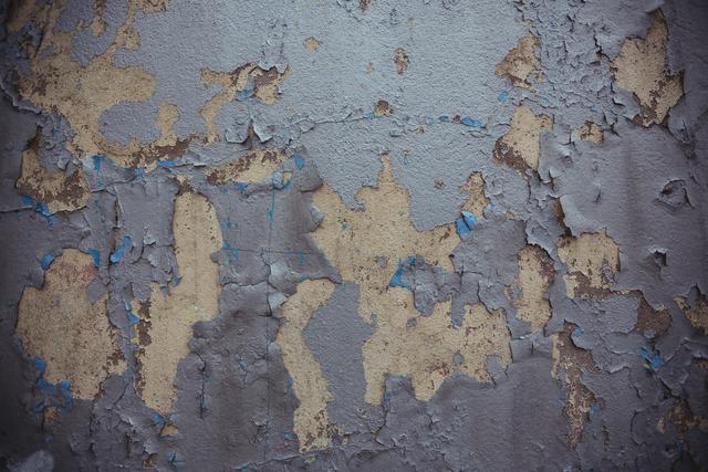 This image of an old wall with peeling paint is perfect for use in design projects that require a grunge or vintage aesthetic. It can be used as a background for websites, posters, and flyers, or as a texture overlay in graphic design and photo editing.