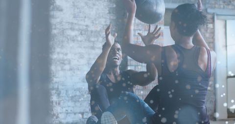 African American Couple Exercising with Medicine Ball in Gym