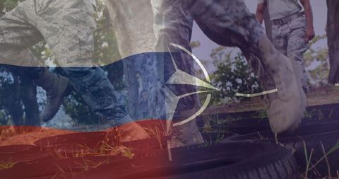 Soldiers training crossing tire obstacle with nato emblem and flag color overlay