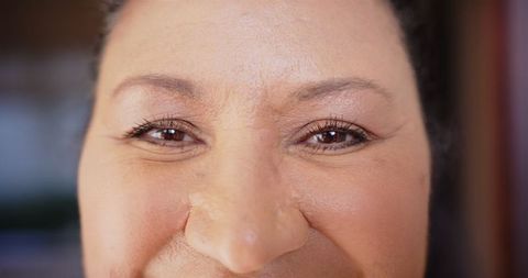 Confident woman's eye close-up celebrating natural beauty