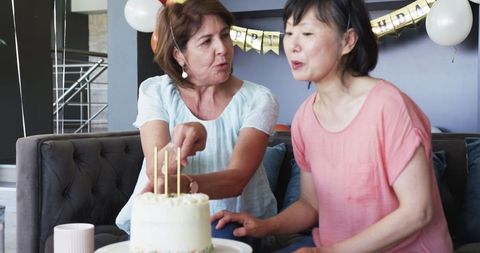 Senior Friends Celebrating Birthday with Cake and Coffee