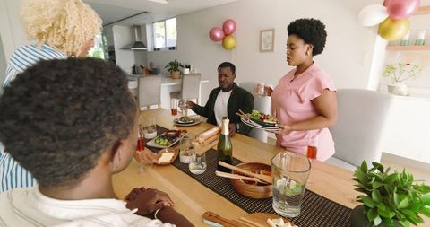 Group of Friends Sharing Lunch at Home in Modern Kitchen