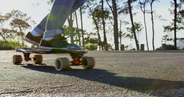 Person Riding Longboard on Asphalt Road at Park - Download Free Stock Images Pikwizard.com