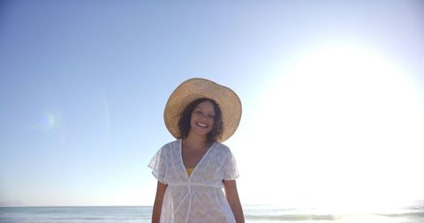 Joyful Woman in Sun Hat Enjoying Sunny Beach Day