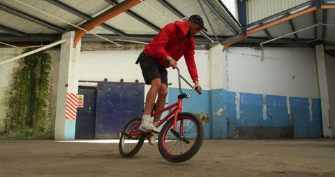BMX Rider Performing Stunt in Abandoned Industrial Setting