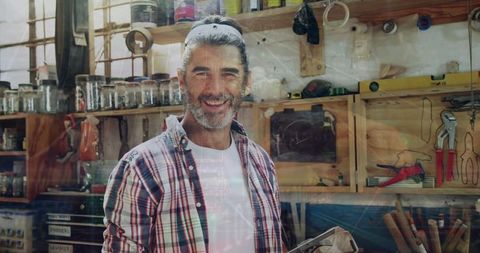 Craftsman in Workshop Holding Tablet Analyzing Work