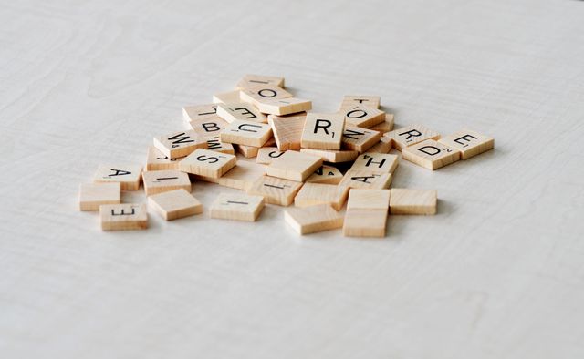 Pile of Blank Wooden Letter Tiles on Light Wooden Surface - Download Free Stock Photos Pikwizard.com