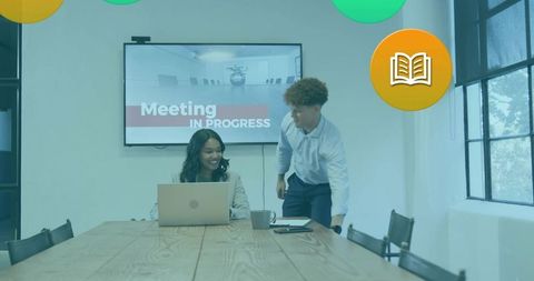 Reviewing presentation and collaborating in modern boardroom during corporate team meeting