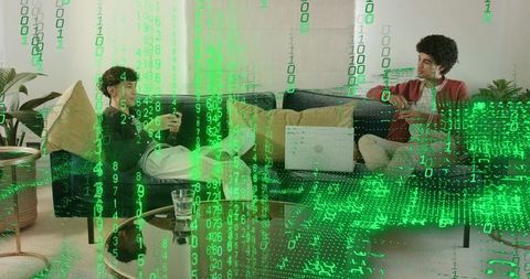 Two friends relaxing on sofa with laptop and phone with green binary data overlay