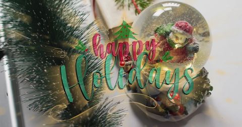 Festive christmas display with snowman snow globe and garland