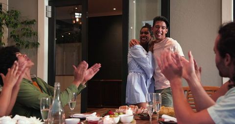 Happy Couple Celebrating with Friends at Cozy Dinner Party